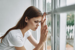 Girl dealing with the stress and loneliness of addiction during COVID-19.